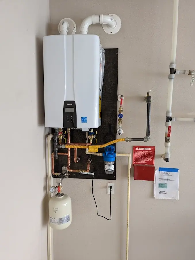 Professional plumber installing copper piping in a Union Mill home